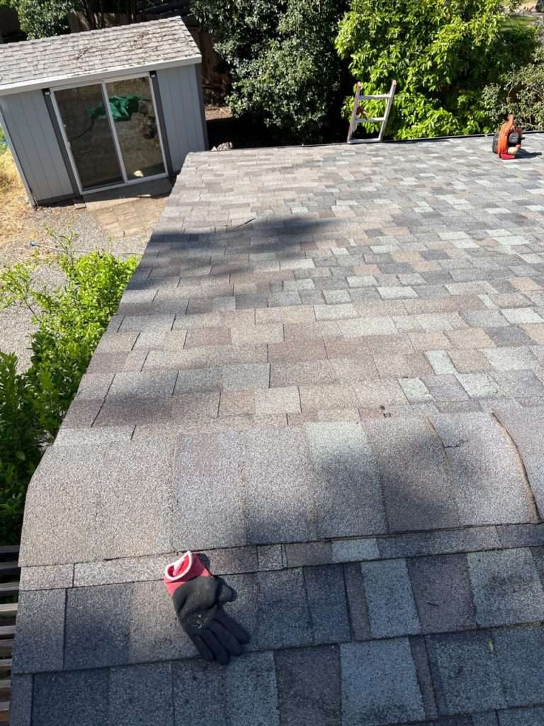 Shingle roof repaired with new matching shingles