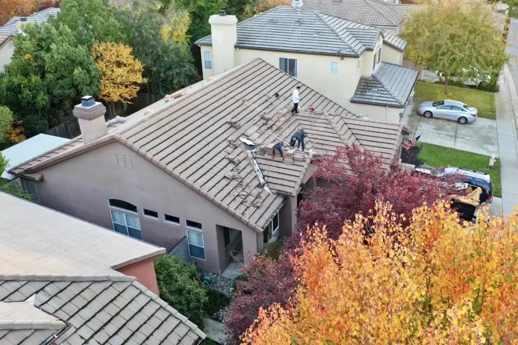 Aerial view of a two-story home with a concrete tile roof