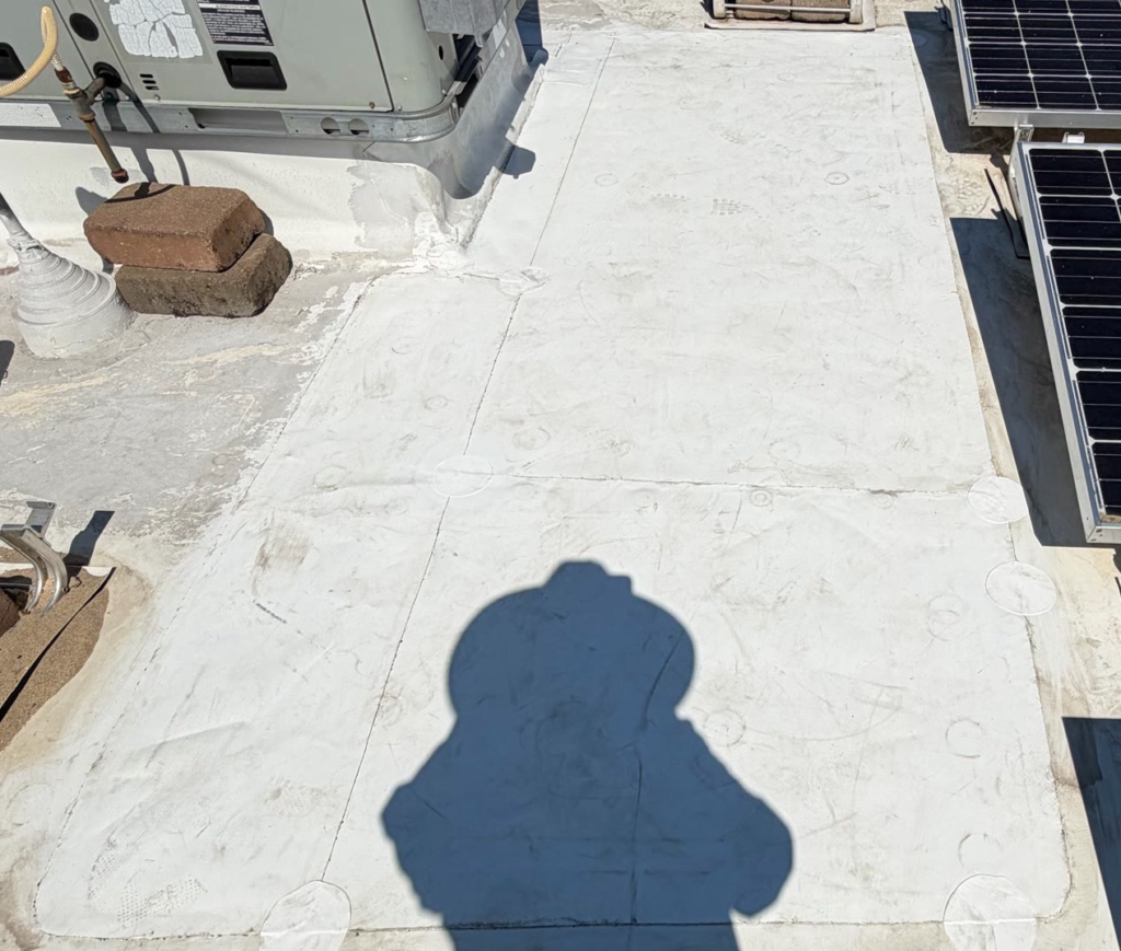 New TPO repair section with welded seams on a commercial flat roof in Auburn after the dry rot was replaced