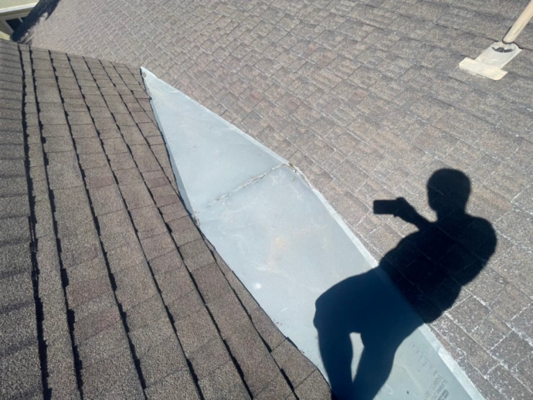Metal cricket on an Elk Grove roof leaking where the seam had opened