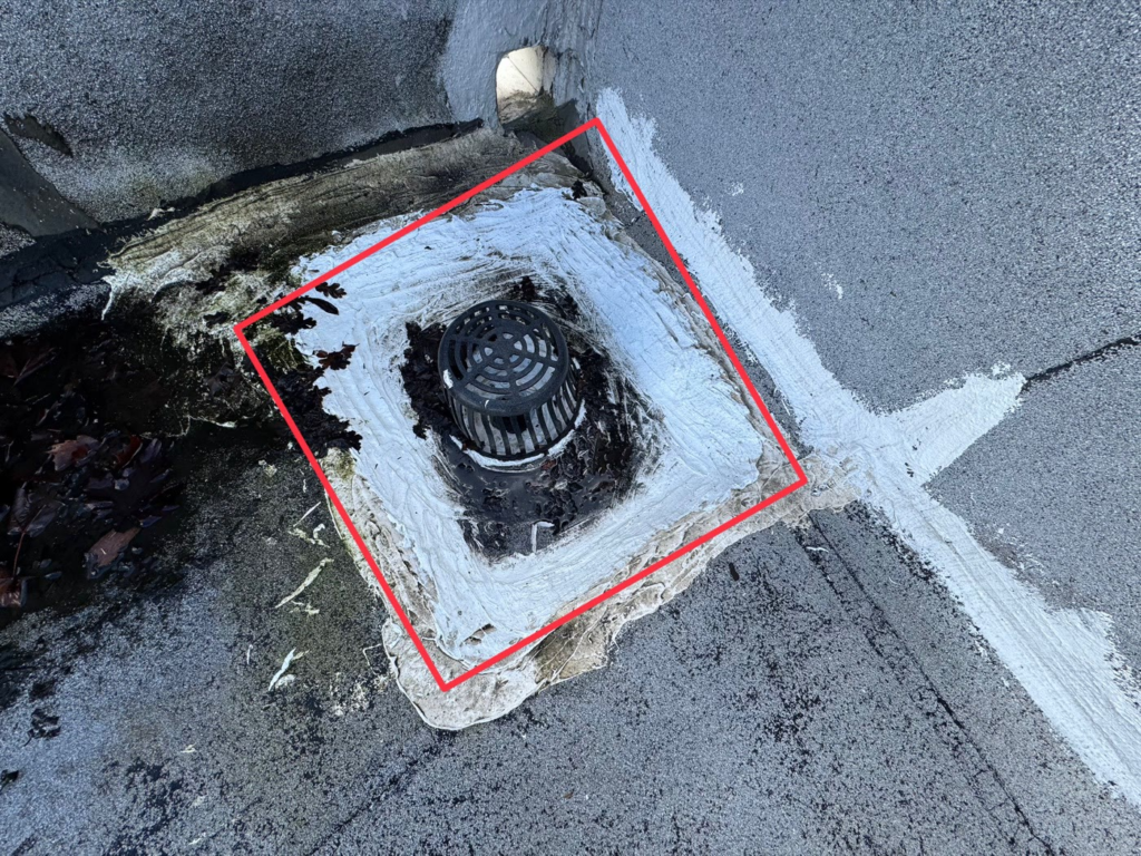 Leaking roof drain on a commercial flat roof in Elk Grove before repair