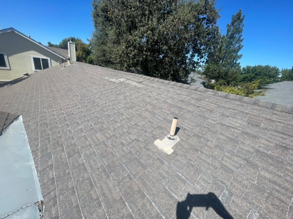 Worn shingle roof in Elk Grove with granule loss and fiberglass showing before replacement