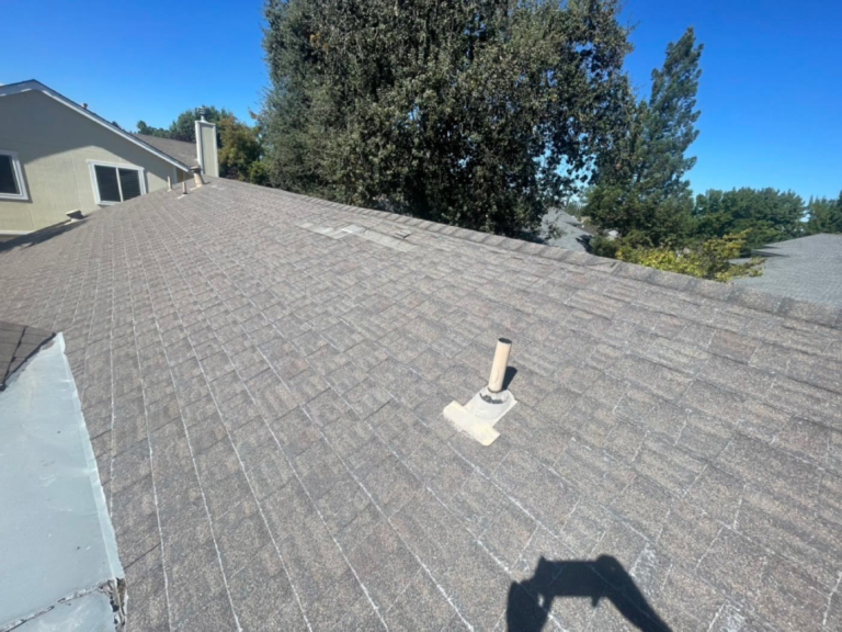 Worn shingle roof in Elk Grove with granule loss and fiberglass showing before replacement