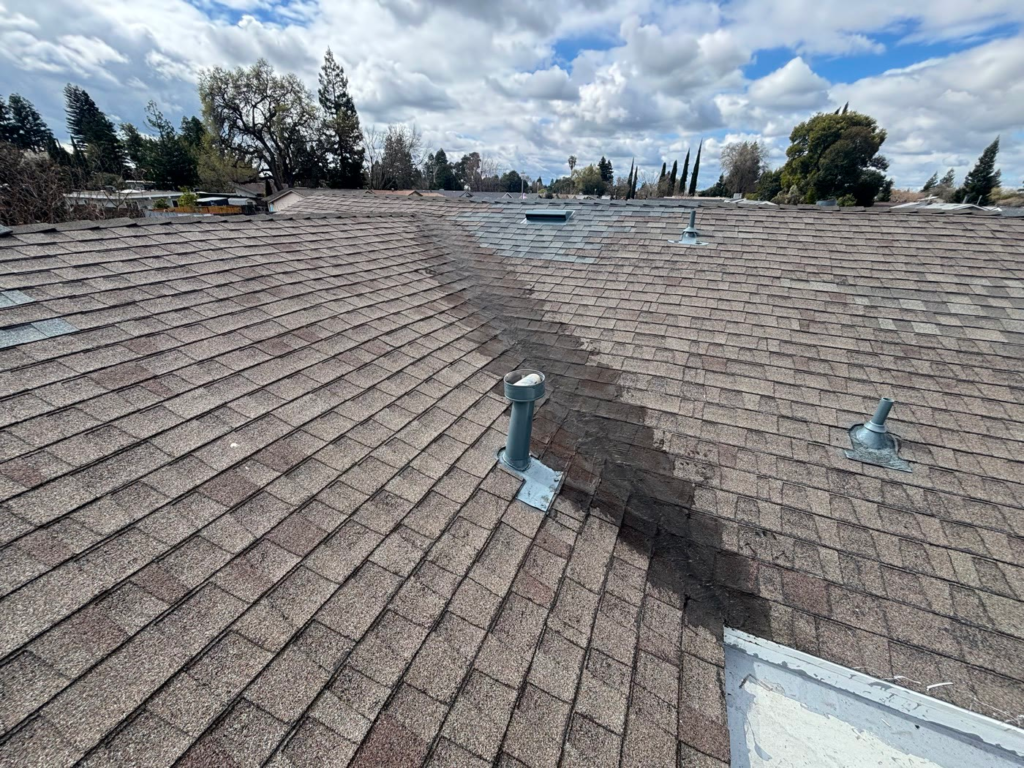 Shingle roof valley in Elk Grove that failed after an earlier patch with mastic