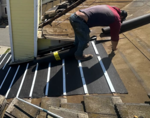 Roof Recovery crew installing new underlayment and water-flow battens around a chimney on an Elk Grove tile roof