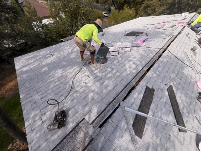 Roof Recovery crew member installing new shingles on a Rocklin roof replacement