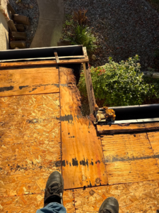 Severe dry rot in the roof decking at the eave, found after the old tile roof was removed in Rocklin