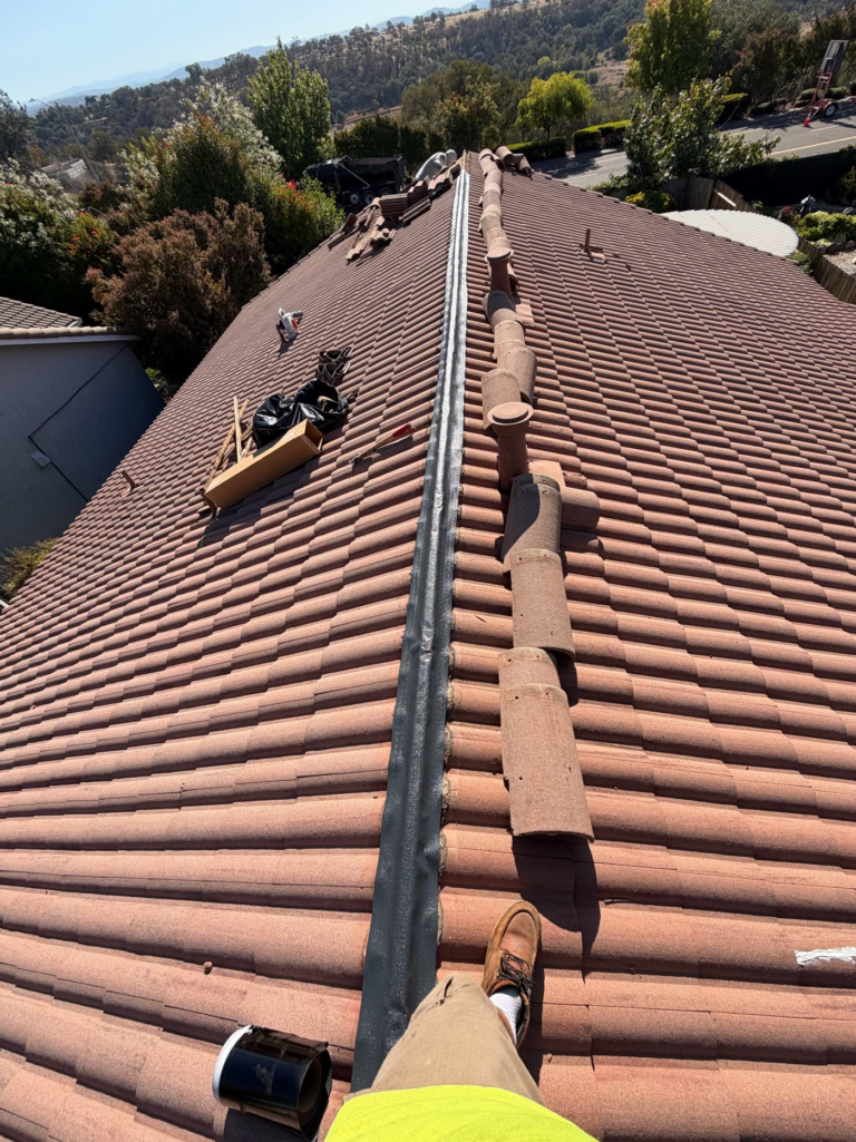 New flash band installed along the full ridge of a Rocklin tile roof before the ridge caps are reset