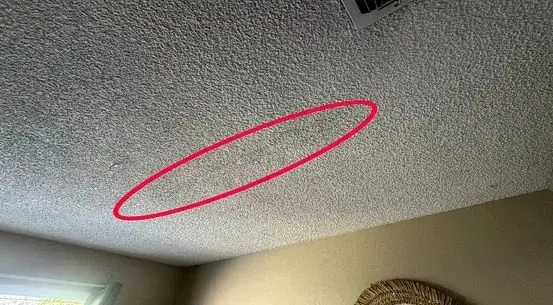 Water stain on a ceiling below a leaking rooftop HVAC unit