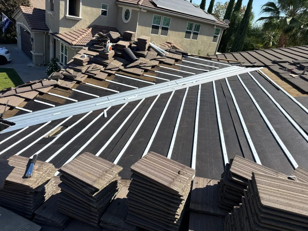 New 30 lb underlayment, water-flow battens and valley metal installed before reinstalling the original tiles