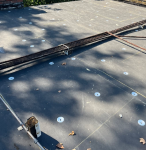 Polyiso insulation board secured with fastening plates over the new deck before the mechanically attached TPO roof in Sacramento