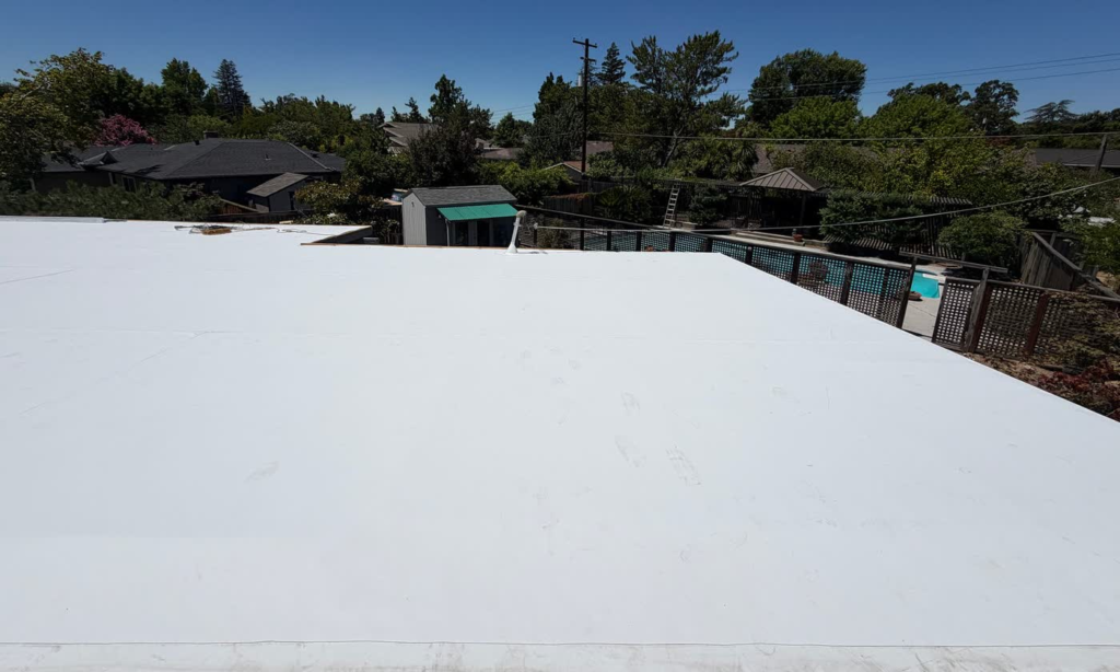 New white TPO flat roof replacement on a Sacramento home
