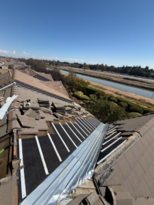 New underlayment, water-flow battens and 5-crown valley metal on a Sacramento tile roof before the tiles go back on