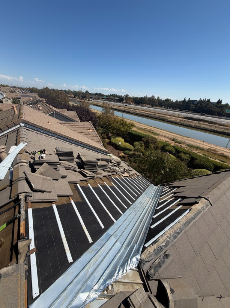 New underlayment, water-flow battens and 5-crown valley metal on a Sacramento tile roof before the tiles go back on