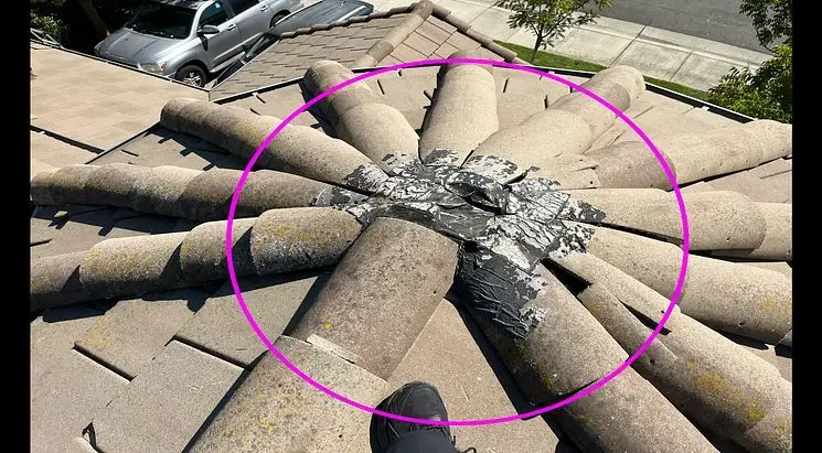 Damaged mortar at the top of a tile roof dome, circled