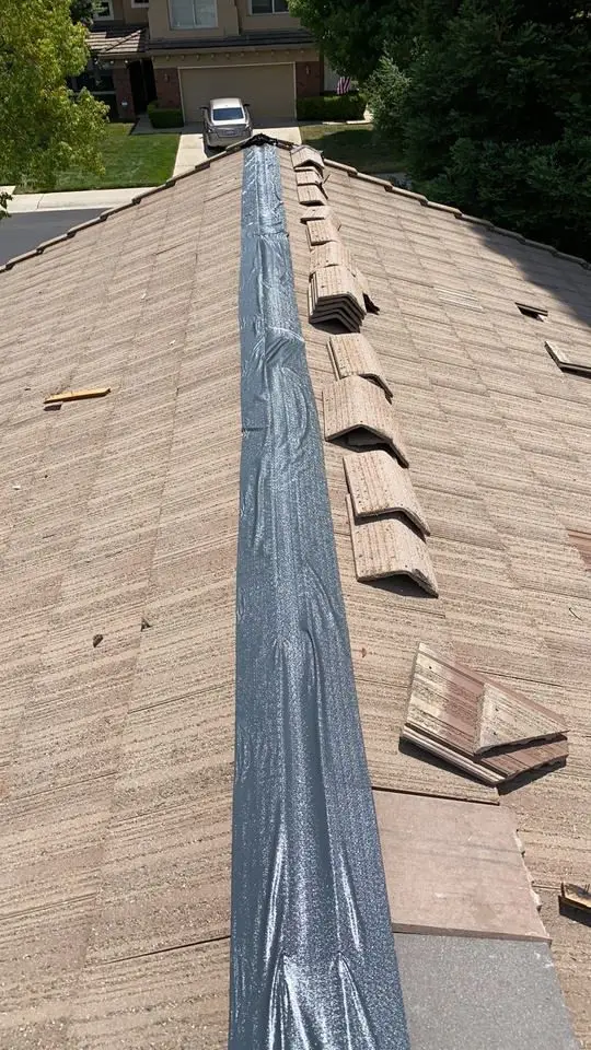 Flash band seal installed along a tile roof ridge