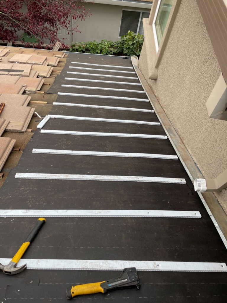 Roof-to-wall section with new underlayment and water-flow battens